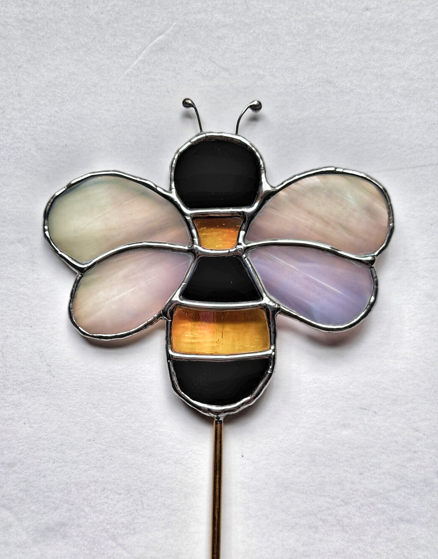 This Planter is handcrafted with shiny black glass, iridescent yellow and iridescent clear glass for the wings.on a solid brass rod.